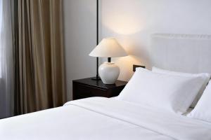 a bedroom with two beds and a lamp on a night stand at Wave Nest 汐宿 in Chongqing