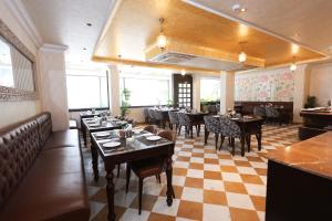 a dining room with tables and chairs in a restaurant at Ved Mahal in Jaipur +20 photos