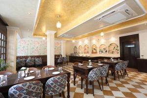 a restaurant with tables and chairs and a piano at Ved Mahal in Jaipur