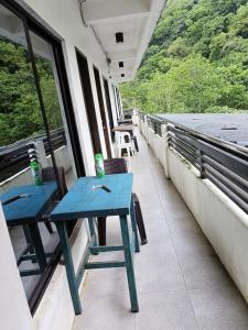 a blue table on the balcony of a train at Chelle's apartelle-inn in El Nido