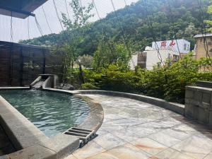 a swimming pool on the side of a building at 旬樹庵　菊水 in Chikuma +8 photos