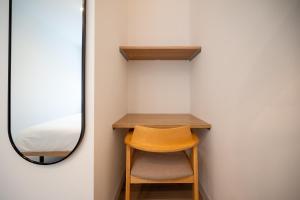 a small room with a chair and a mirror at Grouse Lodge -5 mins to ski field by walk- in Furano