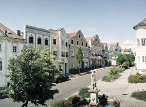 a city street with buildings and a statue in the middle at Studio Apartment - Neufelden in Neufelden