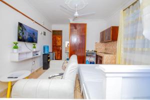 a living room with a white couch and a table at Prilev luxury homes in Mombasa