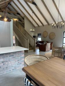 a kitchen and living room with a table and chairs at Fallen Oak Villa 2 in George