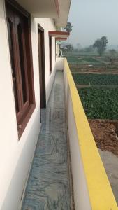 a walkway leading to a building with a window at Sujata Buddha Homestay in Bodh Gaya
