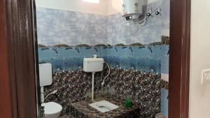 a bathroom with a penguin mural on the wall at Sujata Buddha Homestay in Bodh Gaya