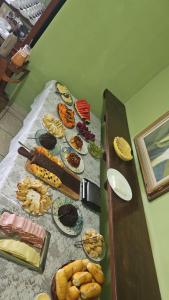 a table with different types of food on it at Pousada do Deck in Alcobaça +18 photos