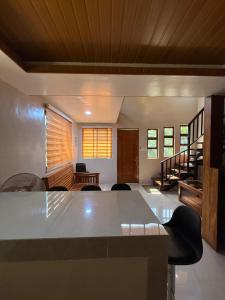 a living room with a table and chairs at R&C Transient House in El Nido