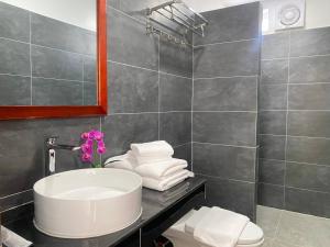 a bathroom with a sink and a toilet and a mirror at HomeStore Apartment in Siem Reap +27 photos