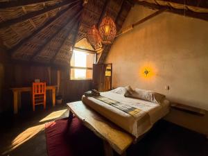 a bedroom with a bed and a wooden table at Casa playa del Amor in San Pedro Pochutla +65 photos