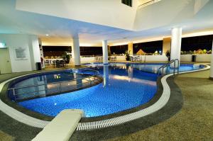 a large swimming pool in a large building at Holiday Villa Hotel & Suites Kota Bharu - Wakaf Che Yeh, Night Market in Kota Bharu