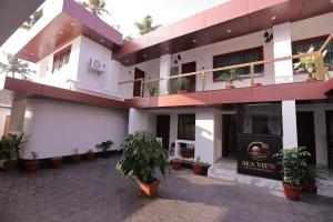 a building with potted plants in the courtyard at Sea View Varkala Beach Resort in Varkala