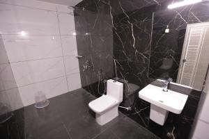 a bathroom with a white toilet and a sink at Sea View Varkala Beach Resort in Varkala +22 photos
