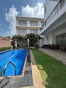 a swimming pool in front of a building at The Suite 262 in Negombo