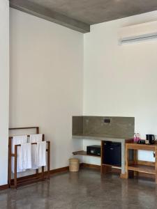 a room with white walls and a table and chairs at Cielo Hiriketiya in Hiriketiya