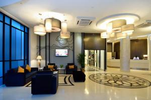 a lobby with couches and a television in a building at Holiday Villa Hotel & Suites Kota Bharu - Wakaf Che Yeh, Night Market in Kota Bharu