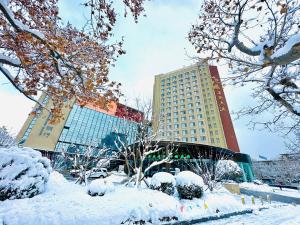 a snow covered city with a building in the background at 威海卫大厦 Weihaiwei Hotel in Weihai