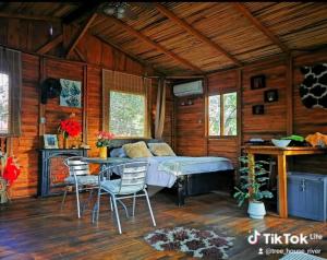 a bedroom with a bed and a table and chairs at Tree House River in Palma