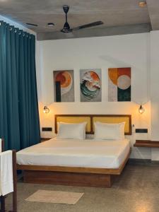 a bedroom with a bed with green curtains at Cielo Hiriketiya in Hiriketiya +45 photos