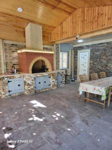 a large kitchen with a brick oven in a room at Shabran Pearl Oasis - Family Garden House - Ailəvi Bağ Evi in Surra