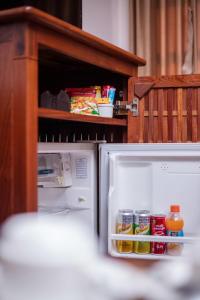 an open refrigerator with food inside of it at Lao Orchid Hotel in Vientiane