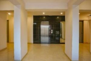 an empty hallway with columns in a building at The Moon Hotel Panvel in Āpta