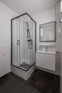 a bathroom with a shower and a sink at Appartement Ann in Blankenberge +6 photos