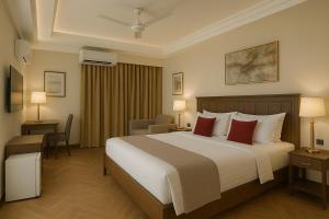 a hotel room with a large bed with red pillows at Diplomat Hotel in Islamabad +57 photos