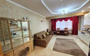 a living room with a couch and a table at Apartments Chisinau in Chişinău