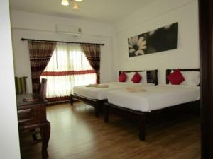 Postel nebo postele na pokoji v ubytování รีสอร์ทที่ลำปาง (Resort At Lampang)