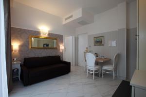 a living room with a couch and a table at Hotel Residence Villa Del Mare in Rimini