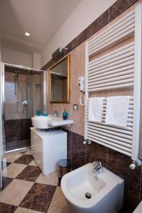 a bathroom with a sink and a toilet and a shower at Hotel Residence Villa Del Mare in Rimini