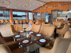 a dining room with a table and chairs at Krishnam Resort in Jabalpur