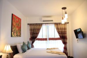 Postel nebo postele na pokoji v ubytování รีสอร์ทที่ลำปาง (Resort At Lampang)