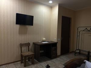 a room with a desk and a television on a wall at GuestHouse Old Avlabari in Tbilisi City