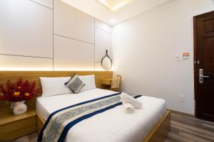 a bedroom with a large bed with white sheets at Phuong Nam Hotel in Ho Chi Minh City