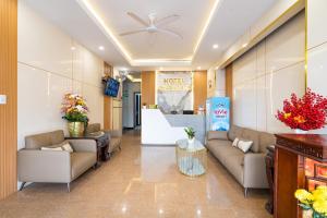 a lobby of a hotel with couches and flowers at Phuong Nam Hotel in Ho Chi Minh City +40 photos