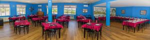 a restaurant with red tables and chairs in a room at Camping de Olite in Olite