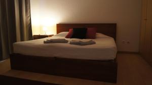 a bedroom with a bed with two towels on it at Alojamento Rural de Covelas in Covelas +23 photos