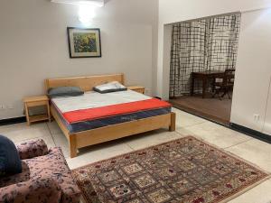 a bedroom with a bed and a living room at New Apartment in Islamabad