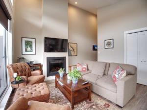 a living room with a couch and a fireplace at Amazing Oceanfront & Eagle Views pet Friendly - 2 bath in Port Renfrew