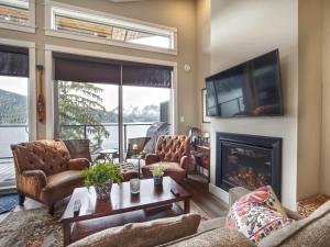 a living room with a fireplace and a tv at Amazing Oceanfront & Eagle Views pet Friendly - 2 bath in Port Renfrew