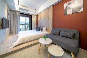 a bedroom with a bed and a couch and a table at Sunlight Heyun B&B in Yuanshan +50 photos