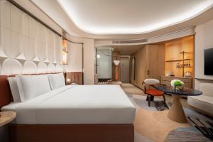 a hotel room with a large bed and a table at Hotel Indigo Xi'an High-tech Zone by IHG in Xi'an