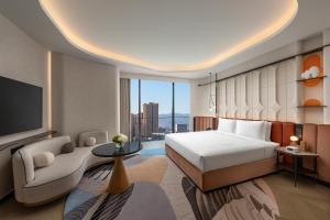 a hotel room with a bed and a tv at Hotel Indigo Xi'an High-tech Zone by IHG in Xi'an