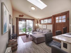a living room with a couch and a table at Tiltin Hilton- Ocean View - Pet Friendly - sleep 4 in Port Renfrew