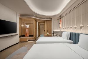 a hotel room with two beds and a tv at Hotel Indigo Xi'an High-tech Zone by IHG in Xi'an +77 photos