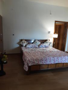 a bedroom with a bed with a floral bedspread at Deepalaya in Guwahati