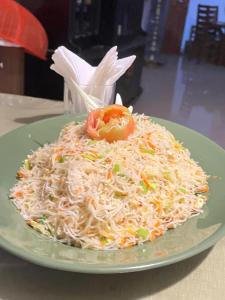 a plate of food with noodles on a table at Green Sapphire Home Stay in Anuradhapura +12 photos